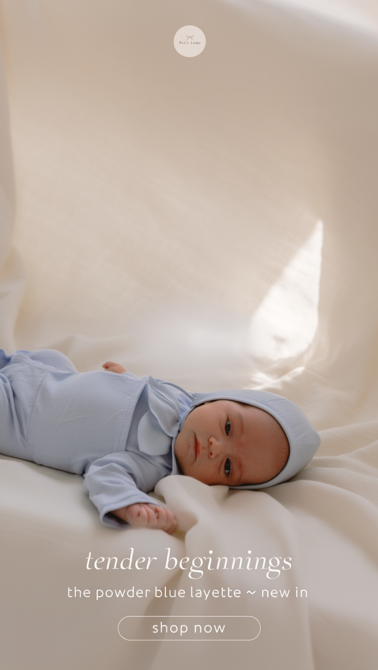 Petit Lu newborn in a powder blue layette set